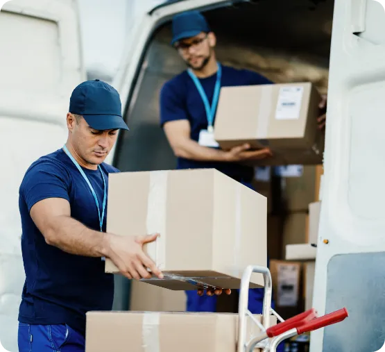 young courier his colleague unloading cardboard boxes from delivery van